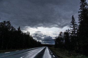 Dramatic northern scandinavian route. Cold northern europe freeway. Nature forest, mountains road perspective view. Travel scenery.