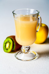 Juicy smoothie from apples and kiwi in a glass cup on a white background
