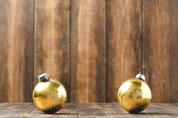 christmas toys of gold color on wooden background with copyspace