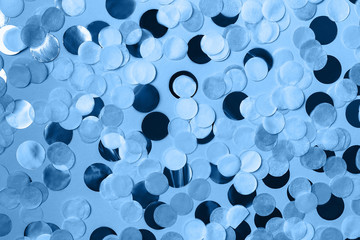 Festive background with round paper confetti in trendy blue color. Holiday concept. Color of the year 2020 concept. Copy space.