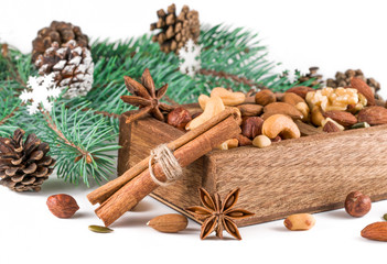 Fototapeta na wymiar .mix of nuts in a box and Christmas tree branches on a white background