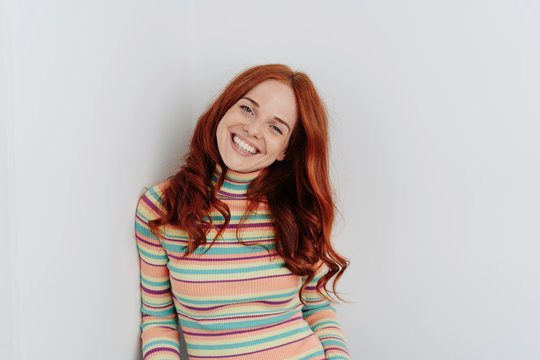 Happy young redhead woman with a cute grin