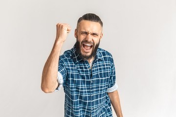 Fototapeta premium Mature bearded man scream, raised fist on hand