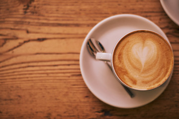 Top view of cappuccino with latte art - heart shape, close up with copy space