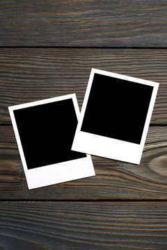 Two blank photocards on brown wooden background