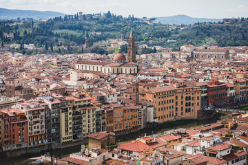 Beautiful super wide-angle aerial view of Florence, Italy with Florence Cathedral di Santa Maria del Fiore, mountains, skyline and scenery beyond the city, seen from the tower of Palazzo Vecchio
