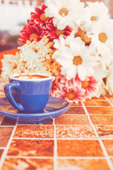 Bouquet of flower and cup of coffee.	