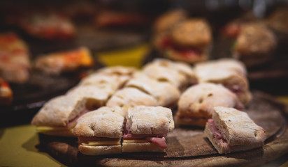 Beautifully decorated catering banquet table with different food snacks and appetizers on christmas birthday party event or wedding celebration, concept of Italian antipasti wine snacks variety set