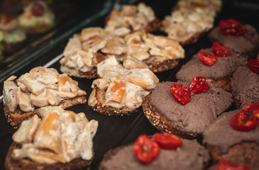 Beautifully decorated catering banquet table with different food snacks and appetizers on christmas birthday party event or wedding celebration, concept of Italian antipasti wine snacks variety set