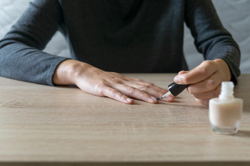 Woman doing the manicure. Removing the polish and putting on the cream. Woman that care his hands. Style concept.