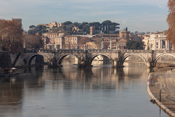 Fototapeta premium Ancient Sant'Angelo Bridge through the Tiber River in Rome in sunny winter morning, Italy