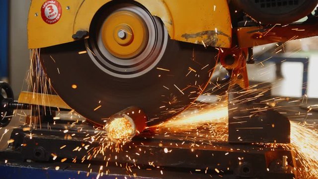 cutting of metal pipe with machine saw at plant construction