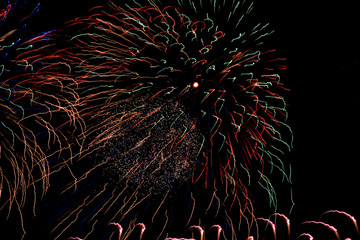 colorful fireworks of different colors lights and glitter on the night sky in summer