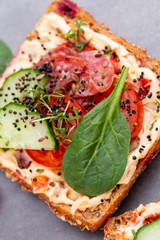 Sandwiches with cream cheese, vegetables and salami.
