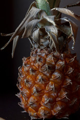 healthy food: ripe pineapple on a dark background