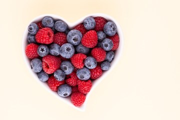 Creative layout made of Blueberry and raspberries on pastel background. Food ingredient pattern.