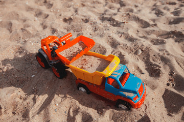 Childrens plastic toys in the sand. Childrens games