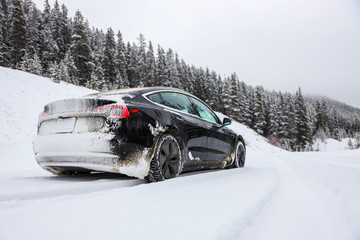 Electric car driving, mountains snow