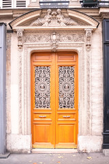 Fototapeta na wymiar Paris, beautiful wooden door, typical building in the Marais, with carved lintel