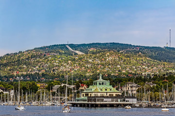 the entrance to oslo on the inlet with the ski jump hill holmenkollen in the background