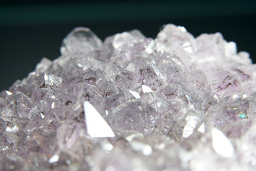 Quartz also called deep quartz with mineral inclusions in the studio in front of black background...