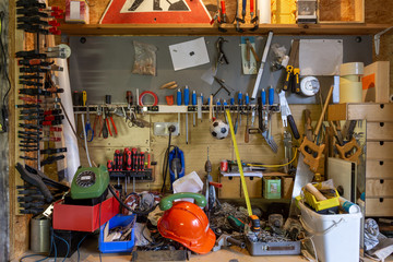 Mess and tools in disorder in a workroom. Equipment, home, interior, rope, dirty, house, messy, objects, stuff, box, chaos, clutter, cluttered