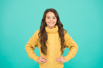 Just wear it. Childhood and girlhood. child in casual winter fashion style. Pure beauty of baby girl. Small girl with long brunette hair. knitting for kids. Little girl on blue background