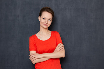 Portrait of happy dreamy young woman imagining something in mind