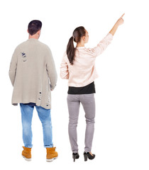 Obraz premium Back view of a stylish couple pointing.