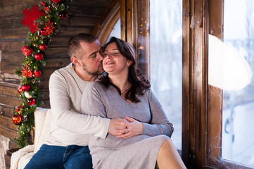 Portrait of a young couple in the living room at Christmas.