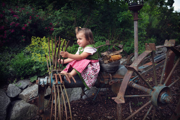 Toddler girl driving imaginary vehicle retro-style