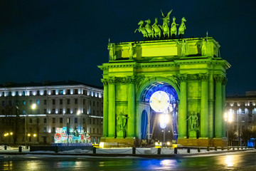 New Year In St. Petersburg. Christmas in Russia. Embellished Narva triumphal gate. Festive decoration of the city. Triumphal gate with green lighting. The train of lights. New year greeting card