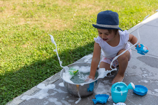Outdoors sensory activity with water for toddlers