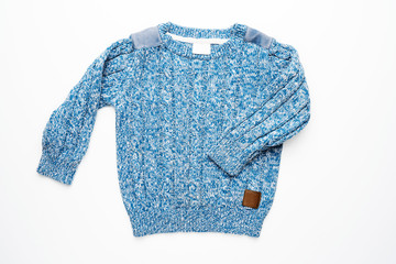 Kids knitted sweater with pattern. Beautiful blue woolen autumn sweater with long sleeves. Front...