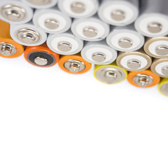 alkaline batteries multi-colored metal and the positive side of the AA-size batteries isolated on white background closeup, carbon zinc batteries, rechargeable batteries, top view mockup