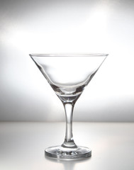 Empty martini glass, cocktail glass isolated with grey background