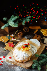 Holiday baking. Christmas cake. Stollen is fruit bread of nuts, spices, dried or candied fruit, coated with powdered sugar. It is traditional German bread eaten in the Christmas season. New year