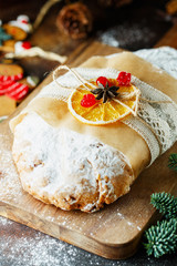 Holiday baking. Christmas cake. Stollen is fruit bread of nuts, spices, dried or candied fruit, coated with powdered sugar. It is traditional German bread eaten in the Christmas season. New year