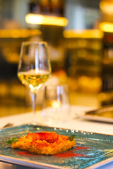 detail of saffron risotto dish with chilli and glass of white wine in a luxury Italian restaurant - 309275161