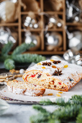Holiday baking. Christmas cake. Stollen is fruit bread of nuts, spices, dried or candied fruit, coated with powdered sugar. It is traditional German bread eaten in the Christmas season. New year