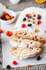 Holiday baking. Christmas cake. Stollen is fruit bread of nuts, spices, dried or candied fruit, coated with powdered sugar. It is traditional German bread eaten in the Christmas season. New year