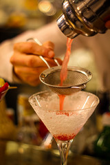 preparation with mixer and colander of cocktails with gin, egg white, lemon juice, granadina and icing sugar - 309275596