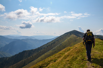 Fototapeta na wymiar Young man on the way to the top of the mountain, Carpathians Ukraine