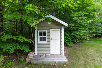 Tiny garden house with siding and door