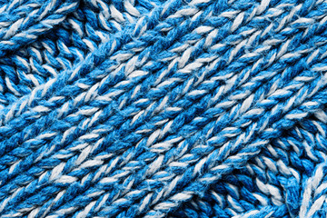 The texture of a knitted blue white sweater. Beautiful textured arana patterns. Background. Copy space