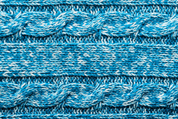 The texture of a knitted blue white sweater. Beautiful textured arana patterns. Background. Copy space