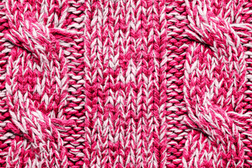 The texture of a knitted red white sweater. Beautiful textured arana patterns. Background. Copy space