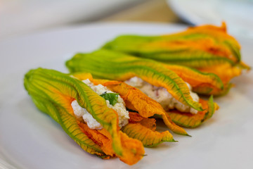 raw pumpkin flowers stuffed and ready to be fried