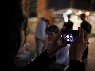 Woman taking picture with digital camera