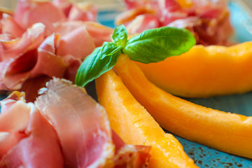 detail of fresh summer aperitif with melon, casertano black pig ham
